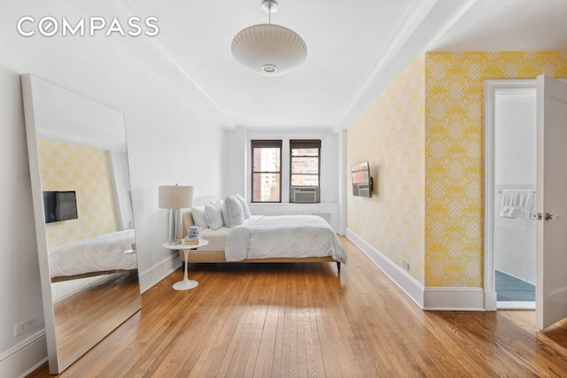 136 E 36th St Unit 9/10C, New York City, NY 10016 - bedroom with wood-type flooring, wallpapered walls, baseboards, and cooling unit