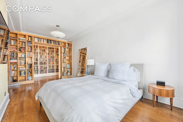 136 E 36th St Unit 9/10C, New York City, NY 10016 - bedroom featuring wood finished floors and baseboards