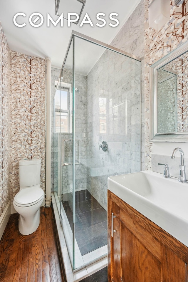 136 E 36th St Unit 9/10C, New York City, NY 10016 - bathroom with vanity, toilet, a shower stall, and tile walls