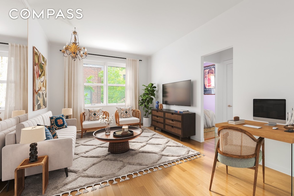 225 E 47th St Unit 6H, New York City, NY 10017 - living area with wood finished floors and a chandelier