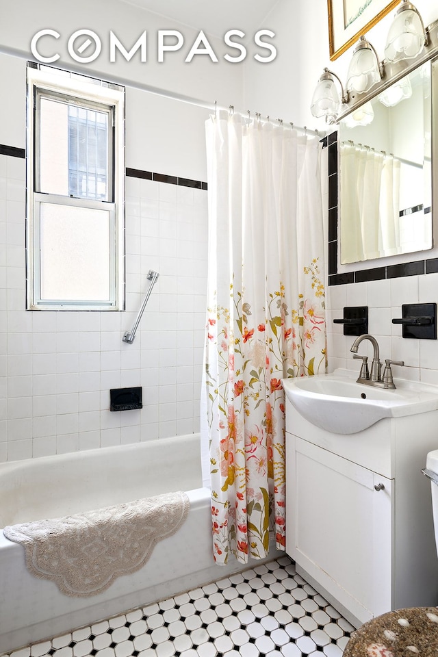 full bathroom featuring shower / bath combo with shower curtain, vanity, and decorative backsplash