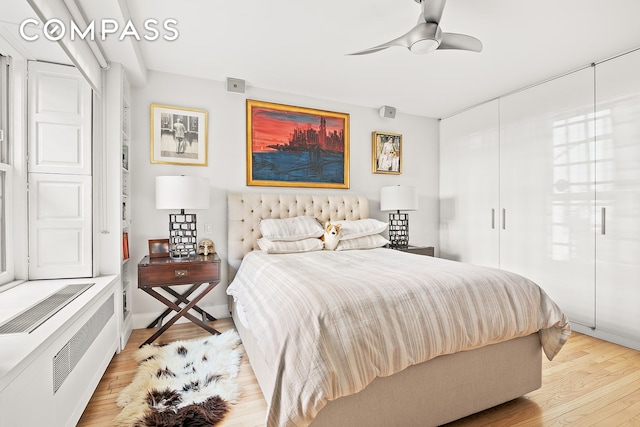bedroom featuring light wood-style floors and a ceiling fan