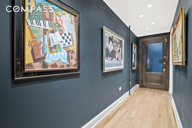 hall with ornamental molding, baseboards, wood finished floors, and recessed lighting