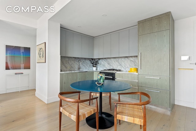 229 9th St Unit 601, New York City, NY 11215 - kitchen featuring light wood-type flooring, backsplash, light countertops, and modern cabinets