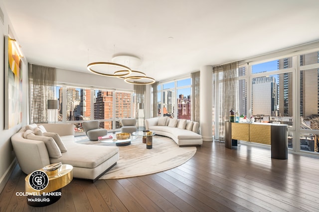 1355 1st Ave Unit 9Fl, New York City, NY 10021 - living room featuring a view of skyline, hardwood / wood-style flooring, a wall of windows, and a chandelier