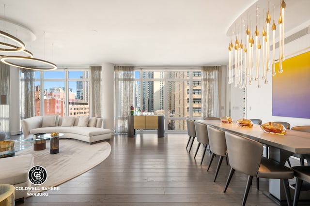 1355 1st Ave Unit 9Fl, New York City, NY 10021 - dining space featuring expansive windows, hardwood / wood-style floors, a view of city, and a chandelier