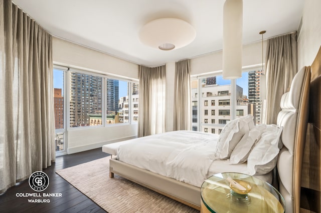 1355 1st Ave Unit 9Fl, New York City, NY 10021 - bedroom featuring a view of city, multiple windows, and wood finished floors