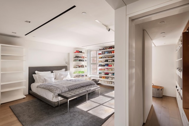 38-40 E 76th St, New York City, NY 10021 - bedroom featuring wood finished floors and rail lighting