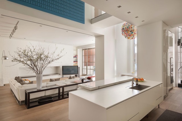 38-40 E 76th St, New York City, NY 10021 - kitchen featuring light wood-style flooring, open floor plan, and light countertops