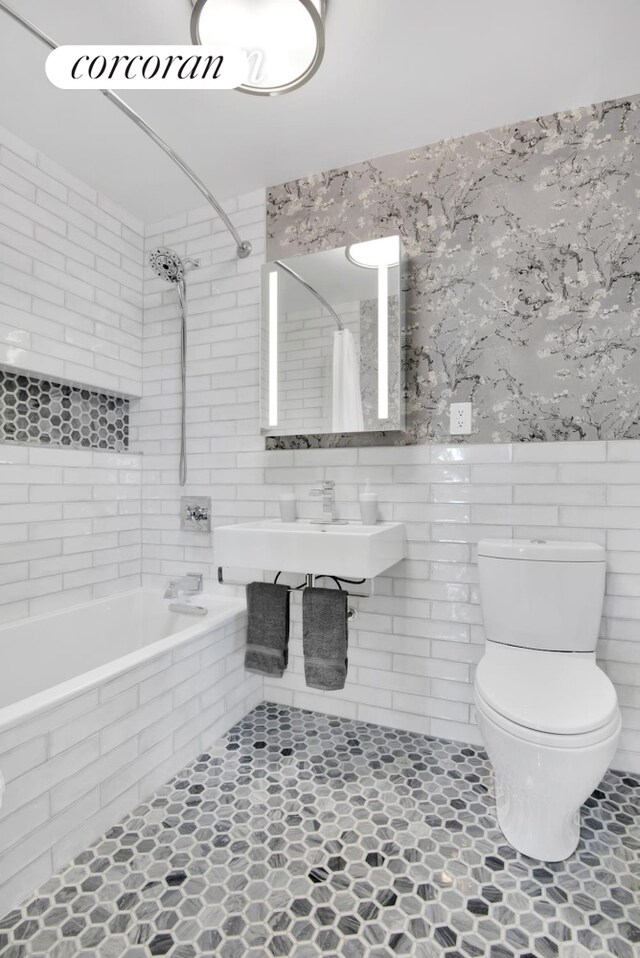 1138 Ocean Ave Unit 8F, New York City, NY 11230 - full bathroom featuring tile walls, tiled shower / bath, toilet, a sink, and tile patterned floors