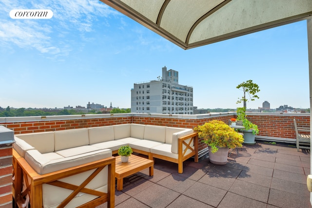 view of patio / terrace featuring a city view and an outdoor living space
