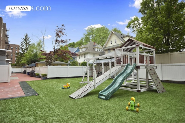 view of play area featuring a fenced backyard and a yard
