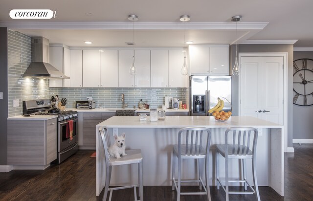 1138 Ocean Ave Unit 8F, New York City, NY 11230 - kitchen with stainless steel appliances, wall chimney range hood, a sink, a kitchen bar, and light countertops