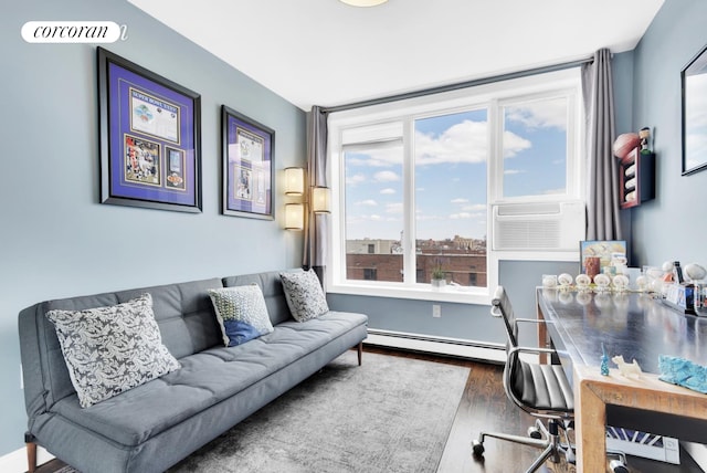office featuring wood finished floors, visible vents, an AC wall unit, and baseboard heating