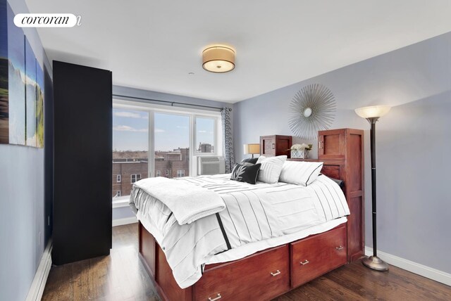 bedroom with visible vents, baseboards, and dark wood finished floors