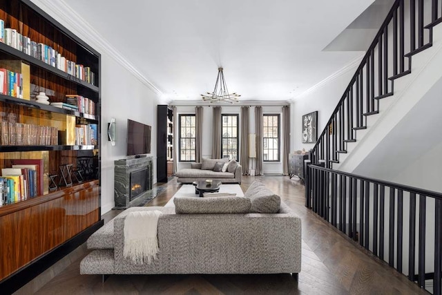 241 E 48th St, New York City, NY 10017 - living area featuring stairs, an inviting chandelier, crown molding, and a premium fireplace