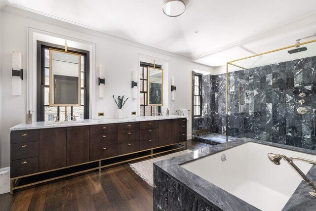 241 E 48th St, New York City, NY 10017 - bathroom featuring a garden tub, ornamental molding, wood finished floors, a marble finish shower, and double vanity