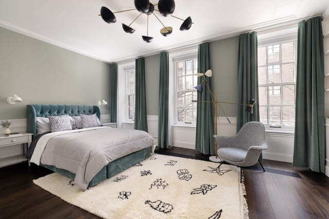 241 E 48th St, New York City, NY 10017 - bedroom with baseboards, ornamental molding, ceiling fan with notable chandelier, and wood finished floors