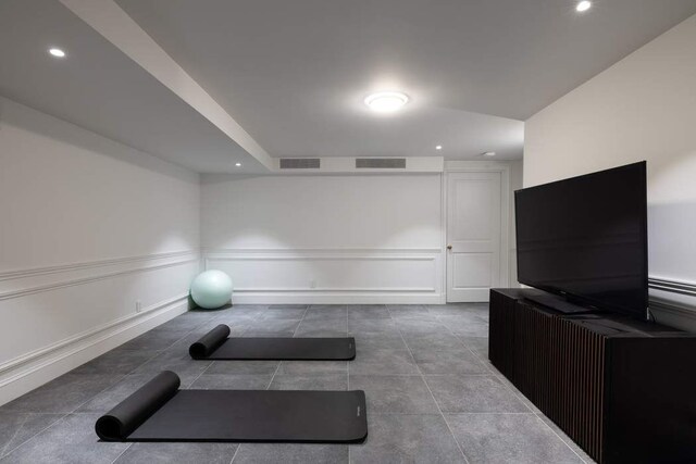 241 E 48th St, New York City, NY 10017 - workout room featuring a decorative wall, visible vents, tile patterned floors, and recessed lighting