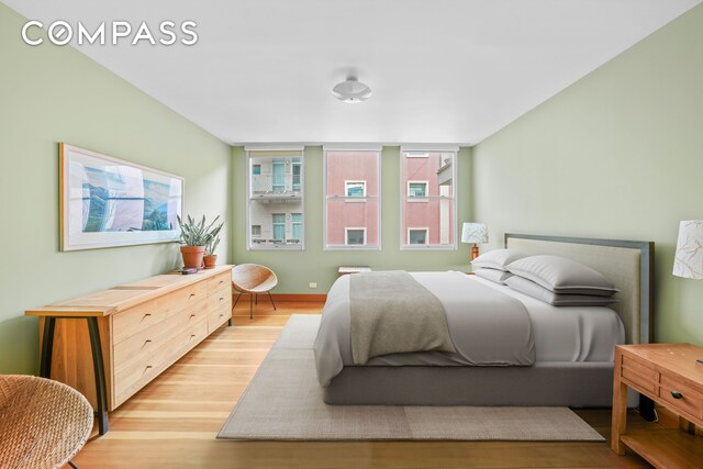 bedroom with baseboards and light wood finished floors