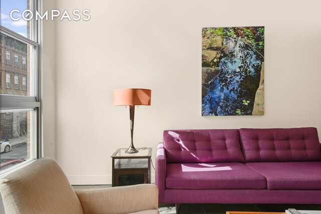 living area featuring baseboards