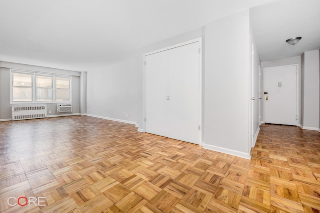 37-31 73rd St Unit 3P, New York City, NY 11372 - unfurnished living room featuring radiator heating unit and an AC wall unit
