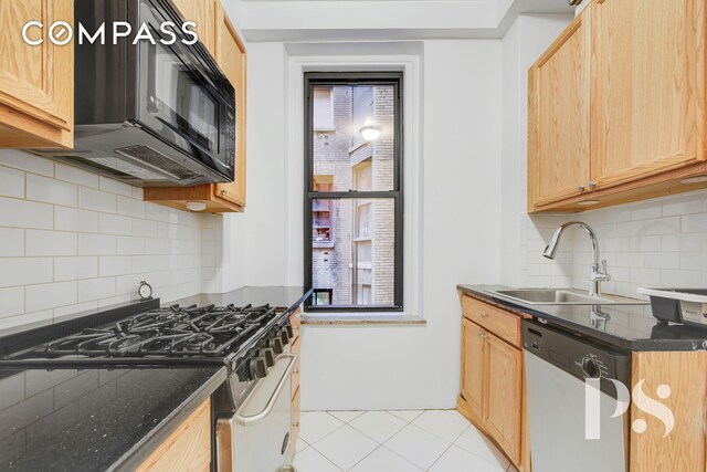 200 W 54th St Unit 6J, New York City, NY 10019 - kitchen featuring white dishwasher, a sink, stainless steel range with gas cooktop, black microwave, and backsplash