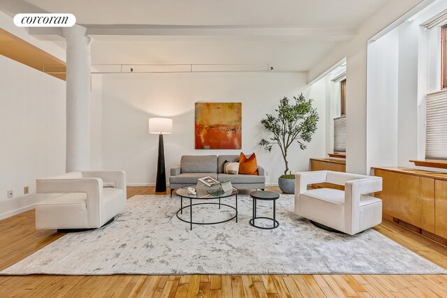 40 W 24th St Unit 6West, New York City, NY 10010 - living area with wood-type flooring, ornate columns, and baseboards