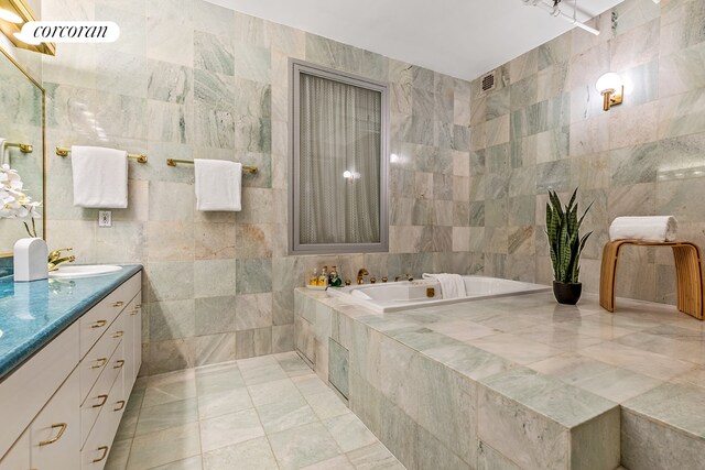 40 W 24th St Unit 6West, New York City, NY 10010 - bathroom with tile walls, vanity, a bath, and tile patterned flooring