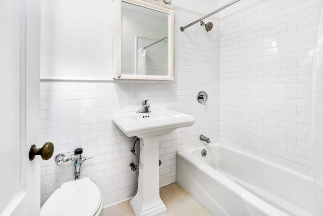 315 W 71st St, New York City, NY 10023 - bathroom featuring tile walls, toilet, shower / tub combo with curtain, and tile patterned floors