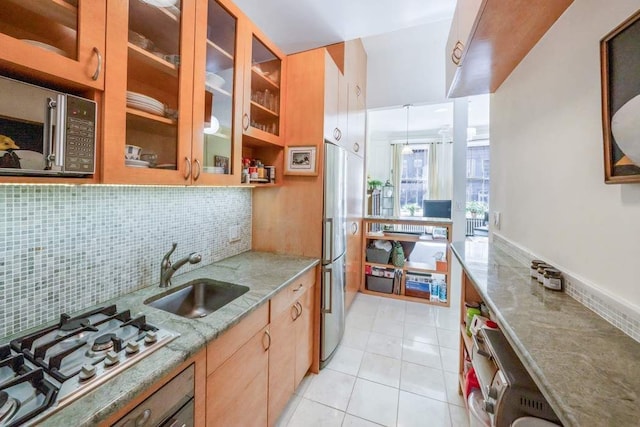 315 W 71st St, New York City, NY 10023 - kitchen with a sink, gas cooktop, light stone countertops, freestanding refrigerator, and decorative backsplash