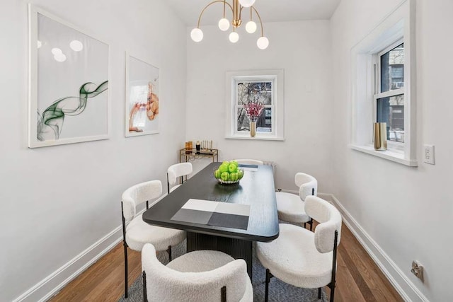 315 W 71st St, New York City, NY 10023 - dining space featuring wood finished floors, a chandelier, and baseboards