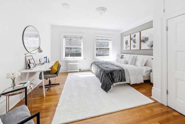 315 W 71st St, New York City, NY 10023 - bedroom with radiator heating unit and light wood-style flooring