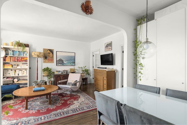 192 E 8th St Unit 6A, New York City, NY 11218 - living room with arched walkways and dark wood-style floors