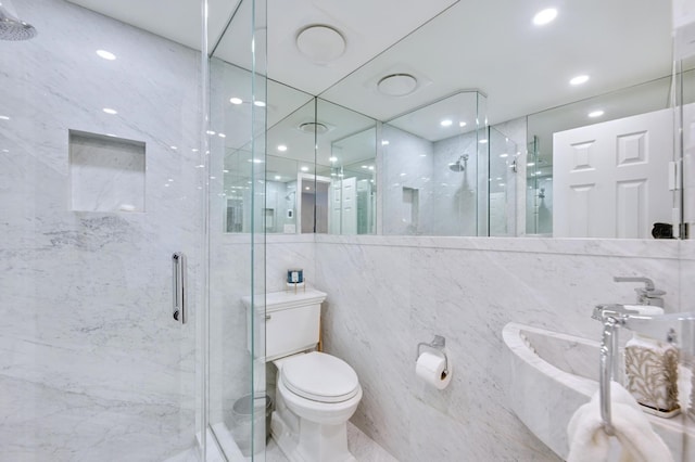 bathroom featuring toilet, a marble finish shower, recessed lighting, and tile walls
