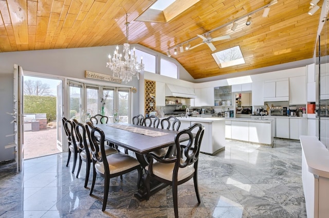 dining area with a notable chandelier, wood ceiling, a skylight, high vaulted ceiling, and marble finish floor
