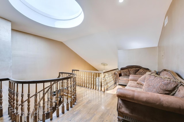 interior space with visible vents, wood finished floors, and lofted ceiling