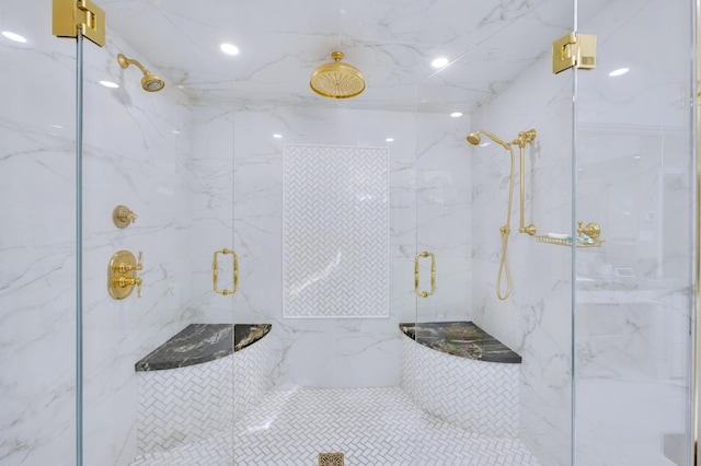 bathroom featuring a marble finish shower