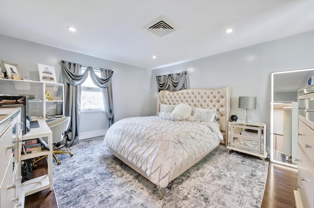 bedroom featuring wood finished floors, baseboards, visible vents, and recessed lighting