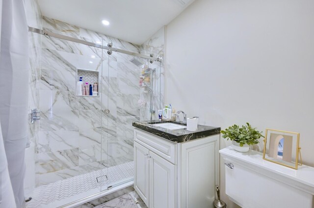 full bathroom featuring a marble finish shower, recessed lighting, and vanity