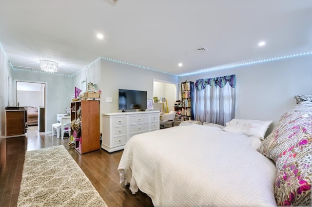 bedroom featuring wood finished floors, visible vents, and recessed lighting