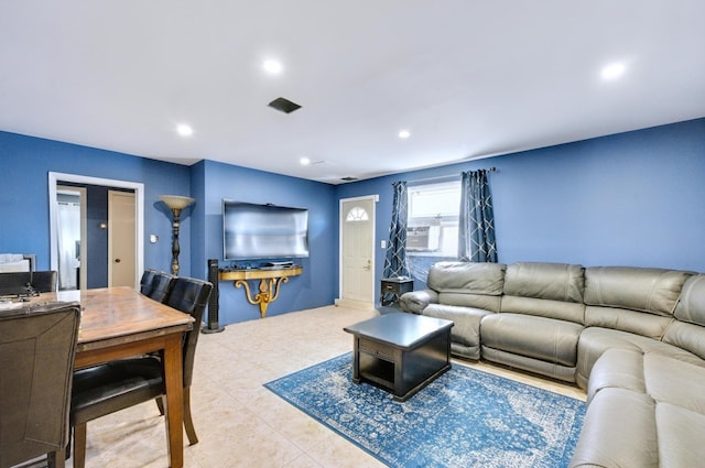 living room featuring recessed lighting, cooling unit, and light tile patterned flooring