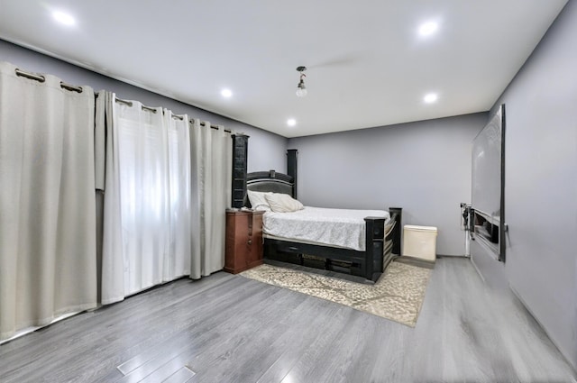 bedroom featuring wood finished floors and recessed lighting