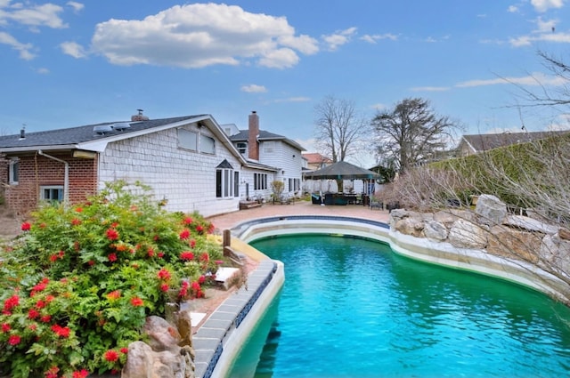 view of pool featuring a patio area, a gazebo, and a fenced in pool