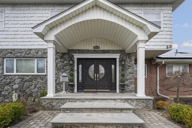 entrance to property with stone siding
