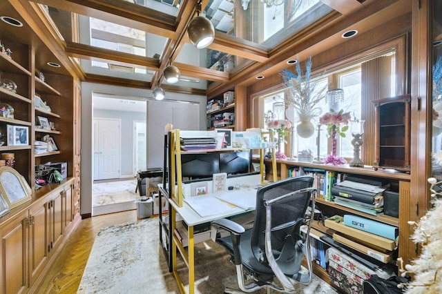 office area with light wood-type flooring and coffered ceiling