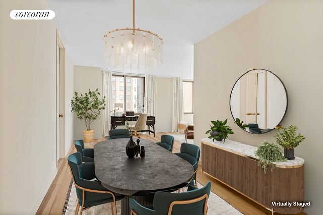 350 W 50th St Unit 28B, New York City, NY 10019 - dining space featuring light wood-type flooring and a chandelier