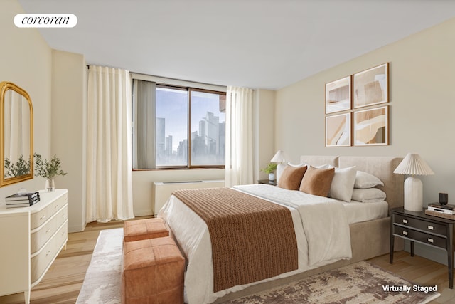 350 W 50th St Unit 28B, New York City, NY 10019 - bedroom with light wood-style floors and baseboards