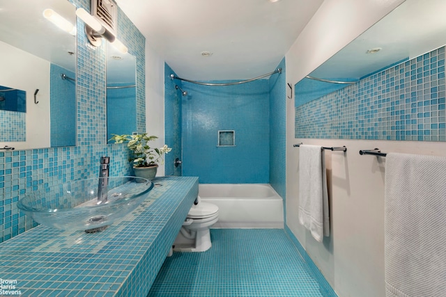 77 Bleecker St Unit 520, New York City, NY 10012 - bathroom with tile walls, toilet, bathing tub / shower combination, tile patterned floors, and vanity