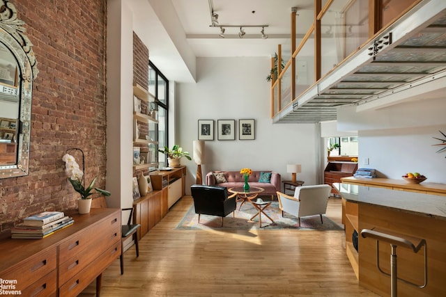 77 Bleecker St Unit 520, New York City, NY 10012 - living room featuring light wood-style floors and brick wall